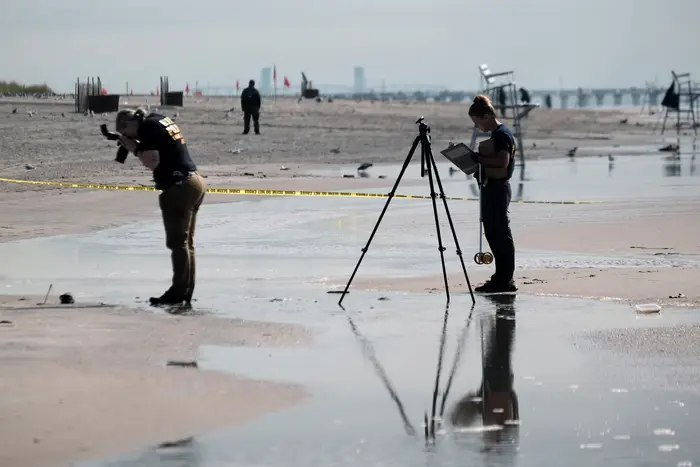 Police work along a stretch of beach at Coney Island after three children were found dead on Monday, September 12th, 2022.
